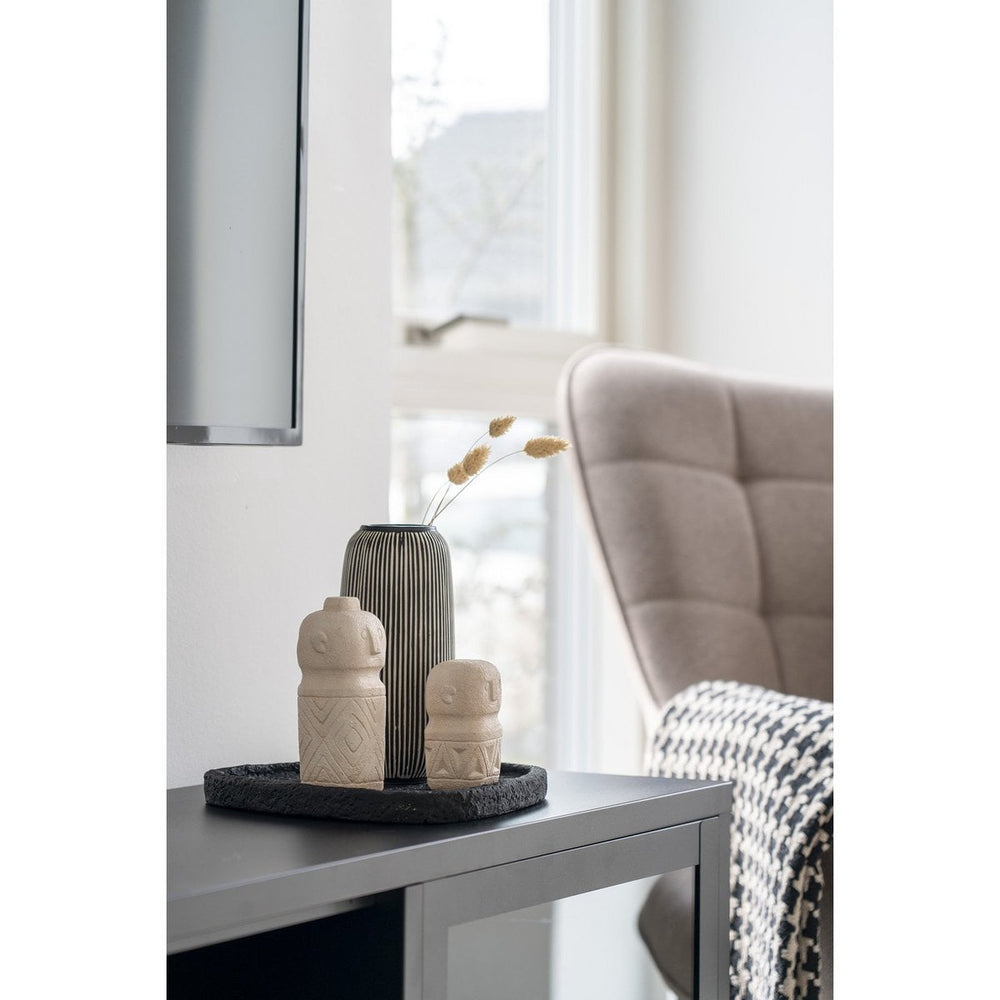 Decorative vases on a side table with a blurred background