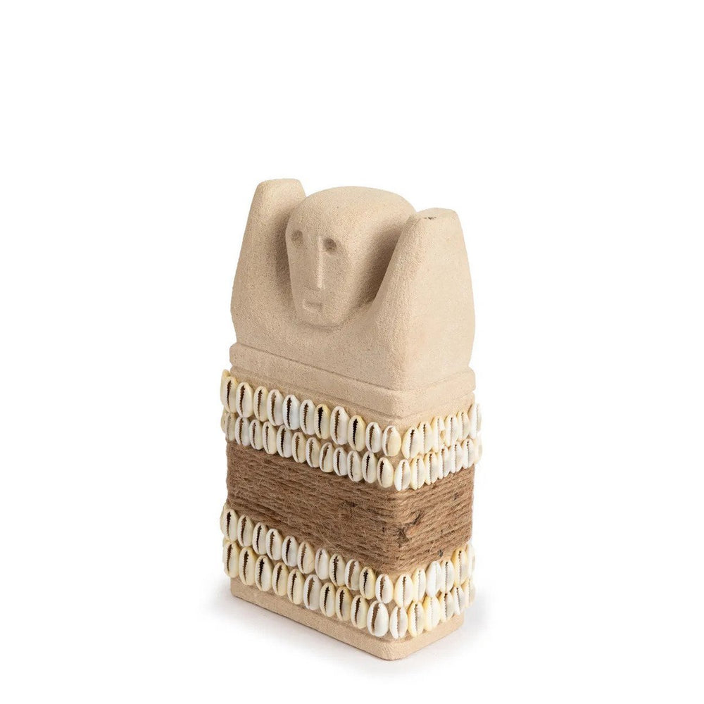 Sandstone statue with cowrie shells and jute wrap