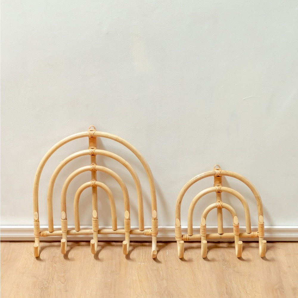 Set of three bamboo arches on a wooden floor against a white wall