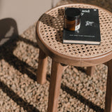 Brown wooden stool with woven rattan seat