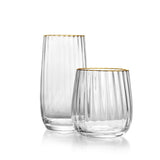 Two clear glass tumblers with gold rims on a white background
