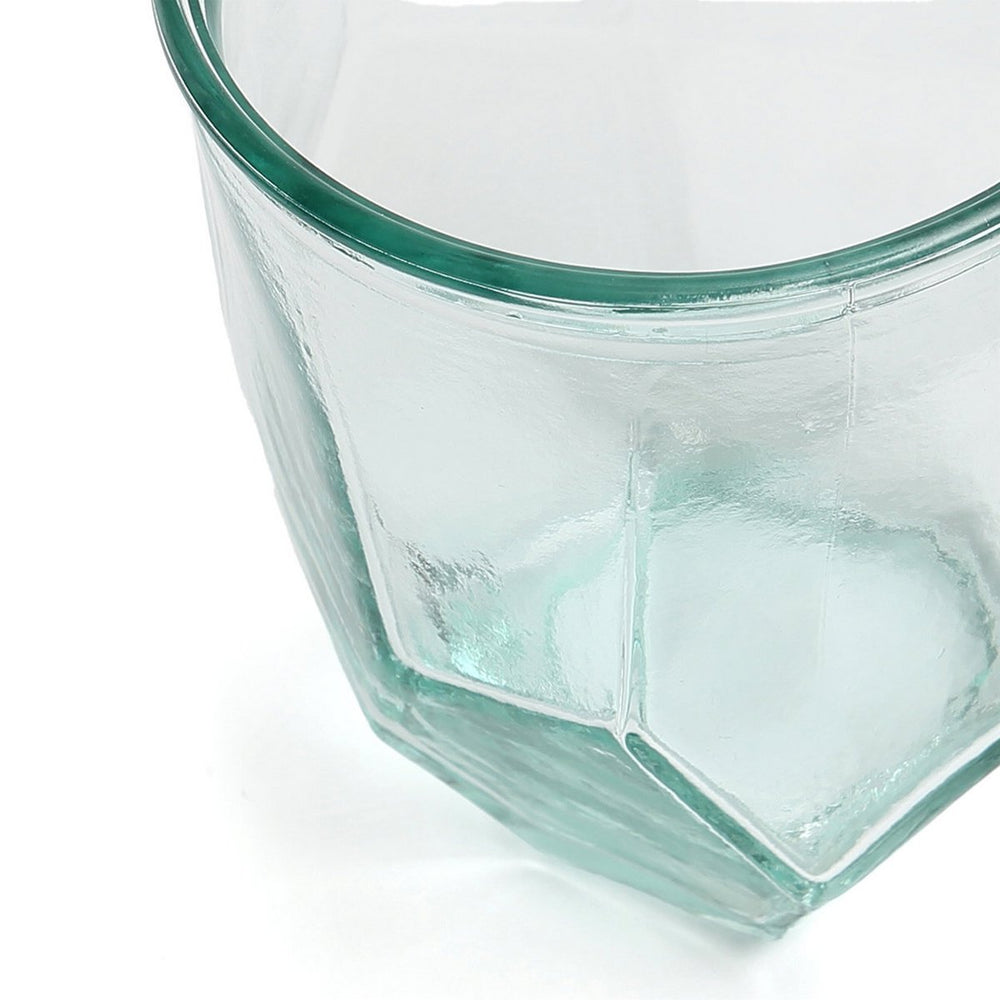 Hexagonal glass container with a green rim on a white background