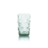 Green glass tumbler with bubble design on a white background