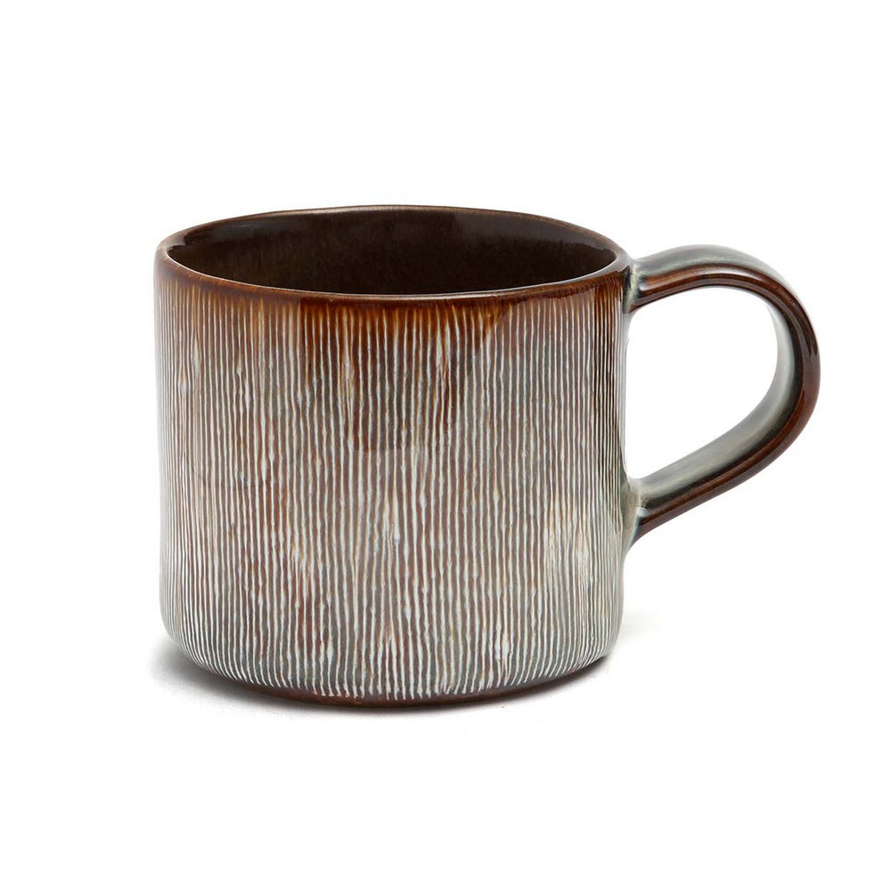Ceramic mug with a textured design on a white background