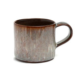 Ceramic mug with a textured design on a white background