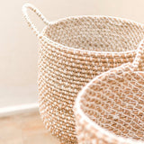 Beige woven banana fibre storage basket with white cotton cord pattern
