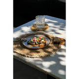 Natural raffia placemat with cowrie shells