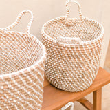 Beige woven banana fibre storage basket with white cotton cord pattern