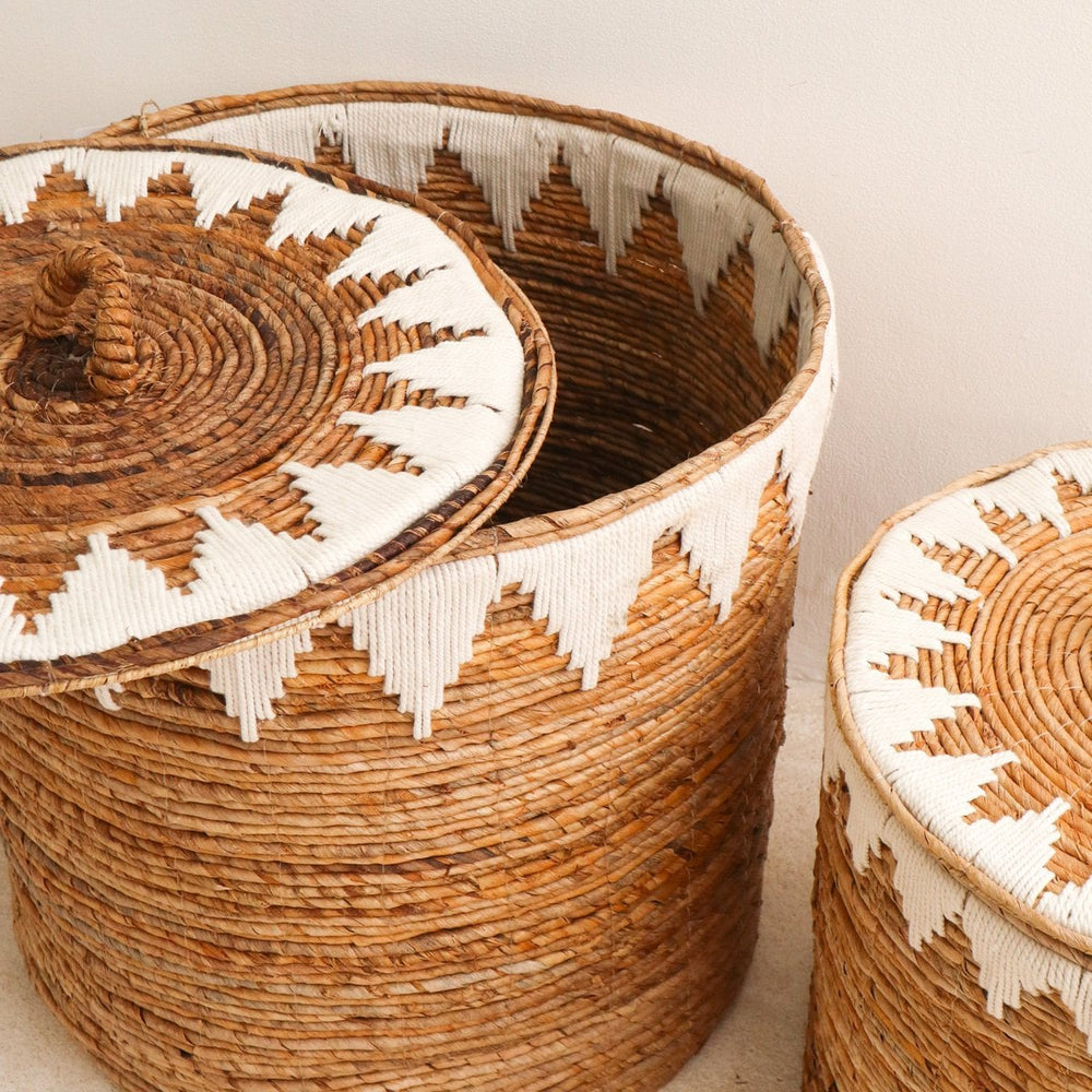 Brown woven banana fibre laundry basket with lid and white cotton macrame pattern