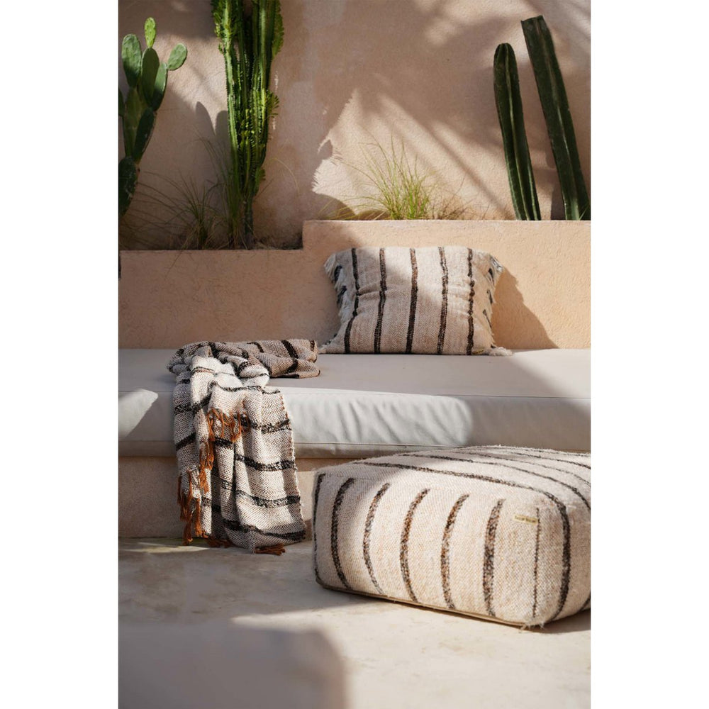 White fringed cotton throw with charcoal stripes and terracotta tassels