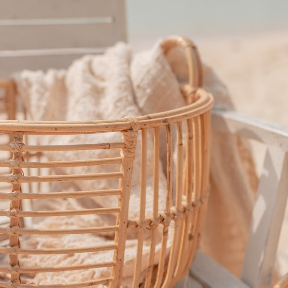 Beige woven rattan laundry basket with handles
