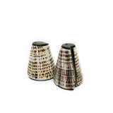 Two ceramic salt and pepper shakers with a spotted pattern on a white background