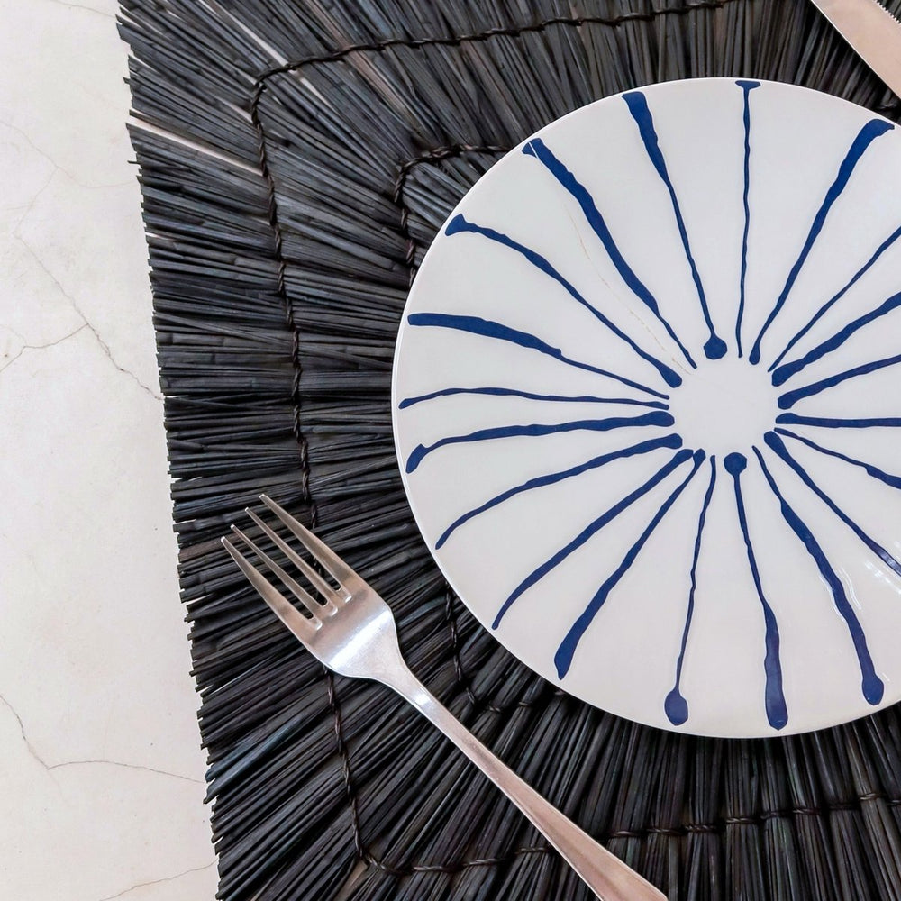Black seagrass placemat with radial woven pattern