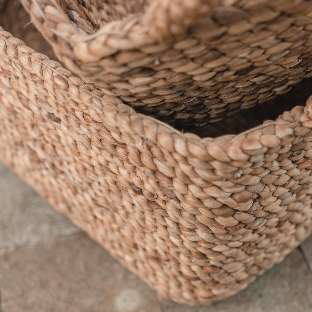 Close-up of two woven baskets on a stone surface