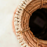 Beige and brown handwoven banana fiber vase with raffia accents