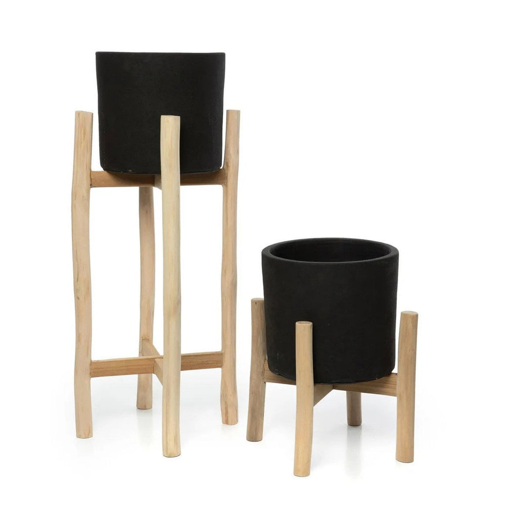 Black terracotta planter on teak branch stand