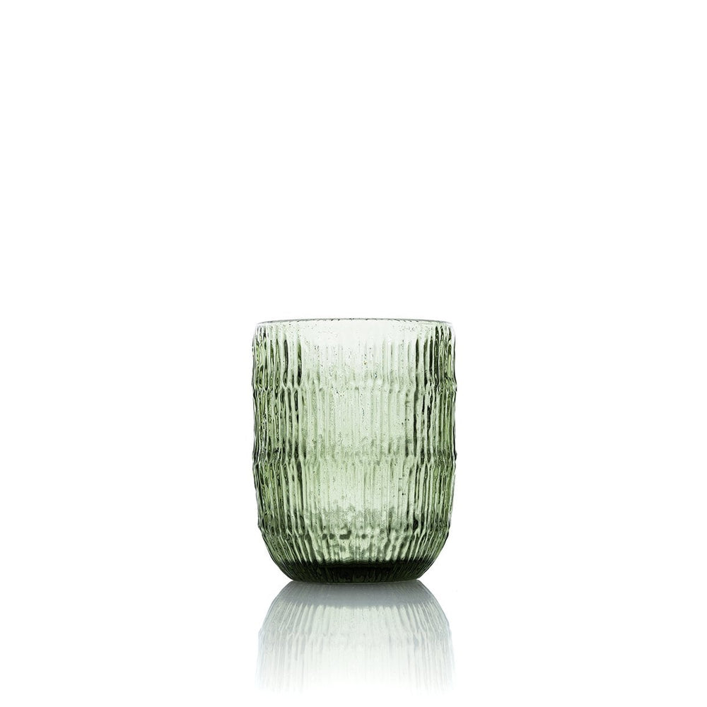 Green textured glass tumbler on a white background