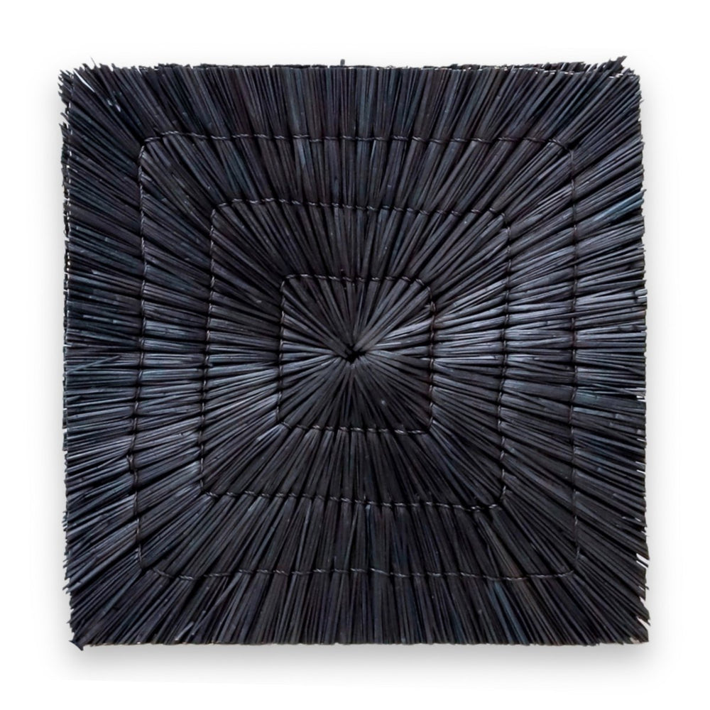 Black seagrass placemat with radial woven pattern