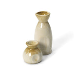 Beige ceramic sauce pourer with white honey glaze