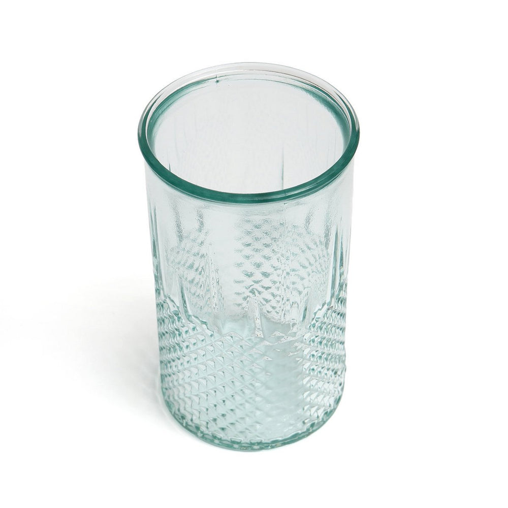 Clear textured glass tumbler on a white background