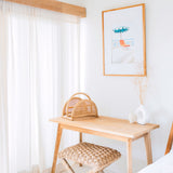Beige woven rattan newspaper rack with handle