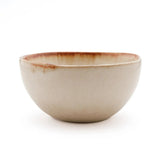 White stoneware cereal bowl with cinnamon-toned drip glaze
