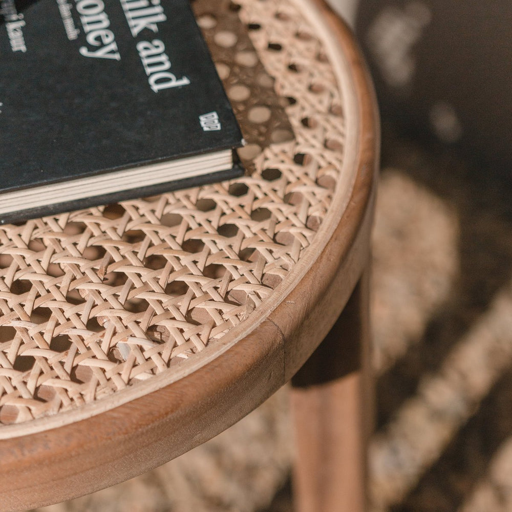 Brown wooden stool with woven rattan seat