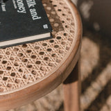 Brown wooden stool with woven rattan seat