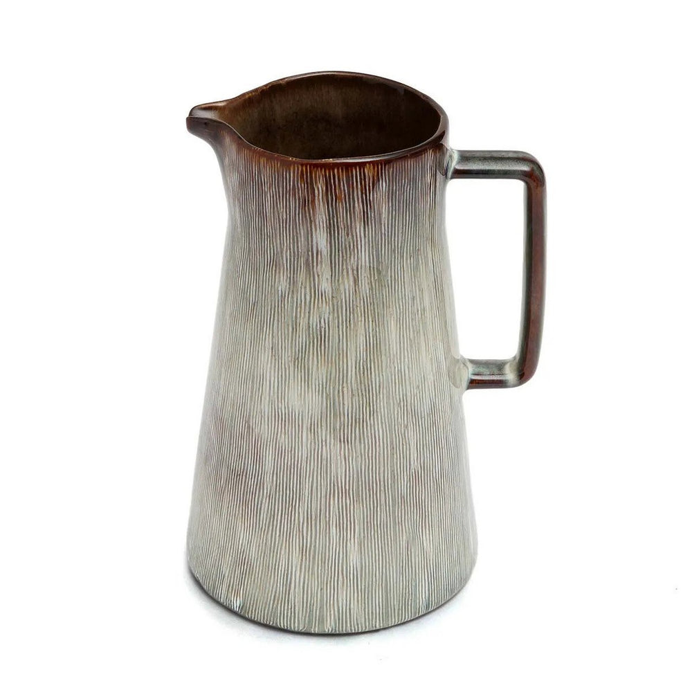 Ceramic pitcher with textured surface and brown rim on a white background