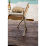 Ceramic candle holder on a wooden surface with a blurred outdoor background