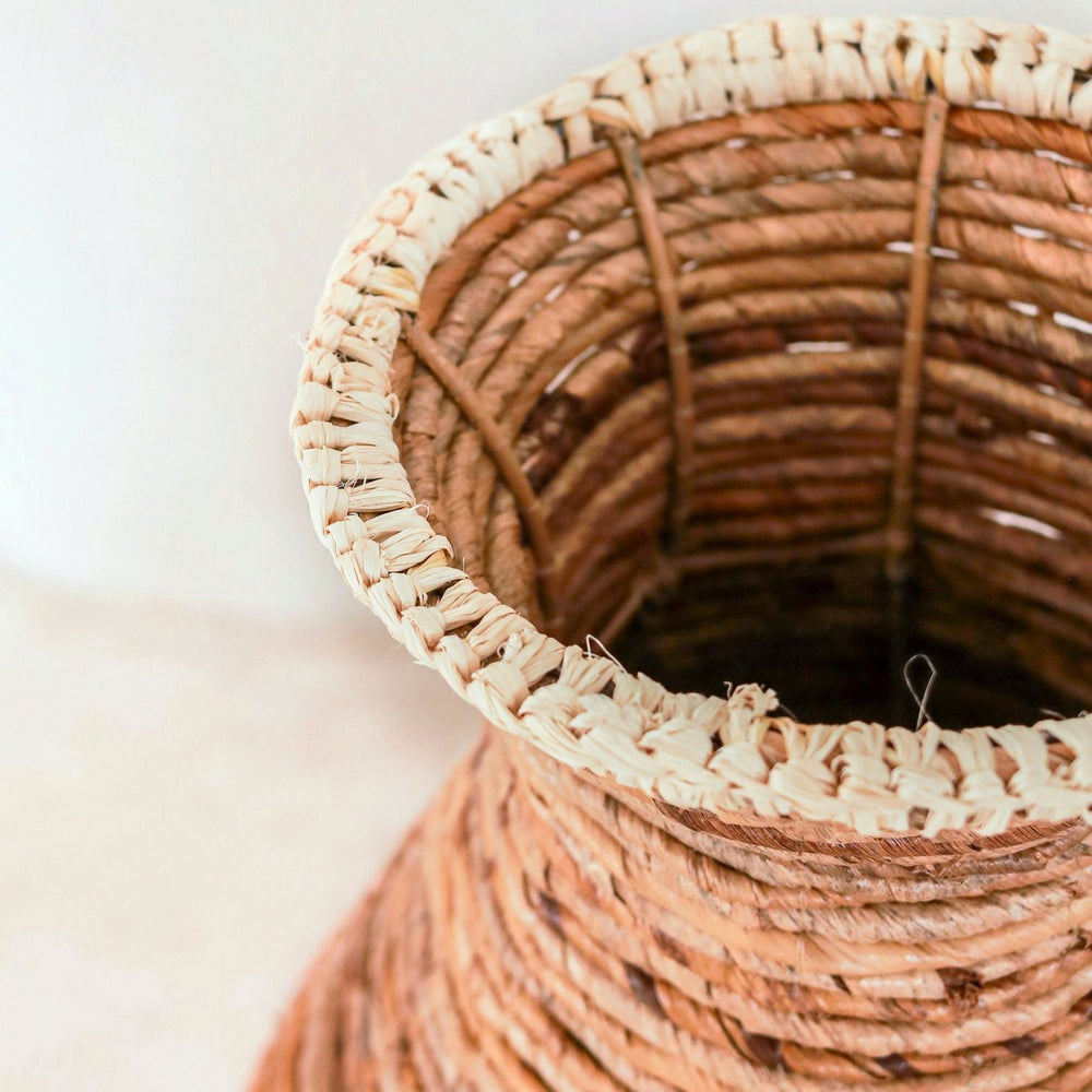 Beige and brown handwoven banana fiber vase with raffia accents