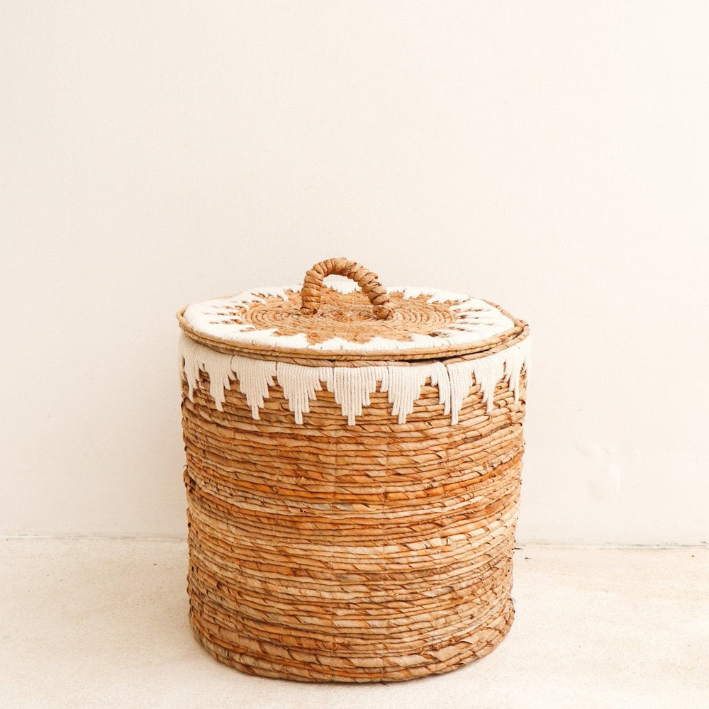 Brown woven banana fibre laundry basket with lid and white cotton macrame pattern