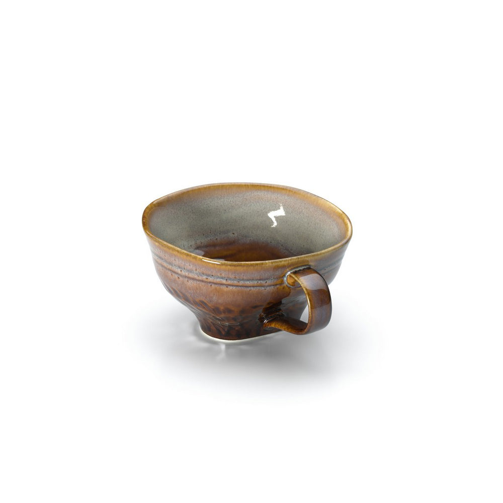 Ceramic cup with brown and gray glaze on a white background