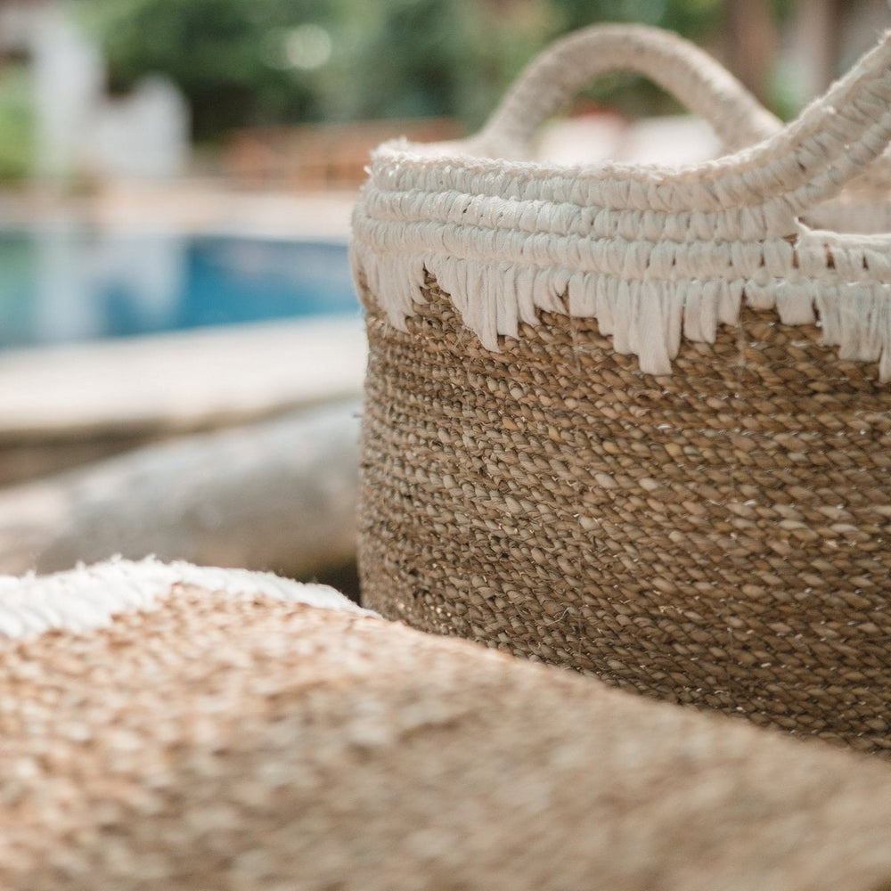 White woven seagrass storage basket with handles