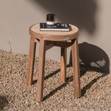 Brown wooden stool with woven rattan seat