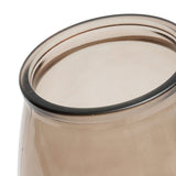 Close-up of a beige glass with a black rim on a white background