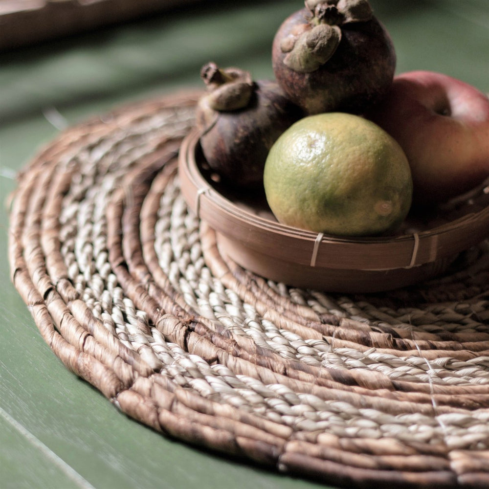 Fruit in a woven bowl on a textured surface