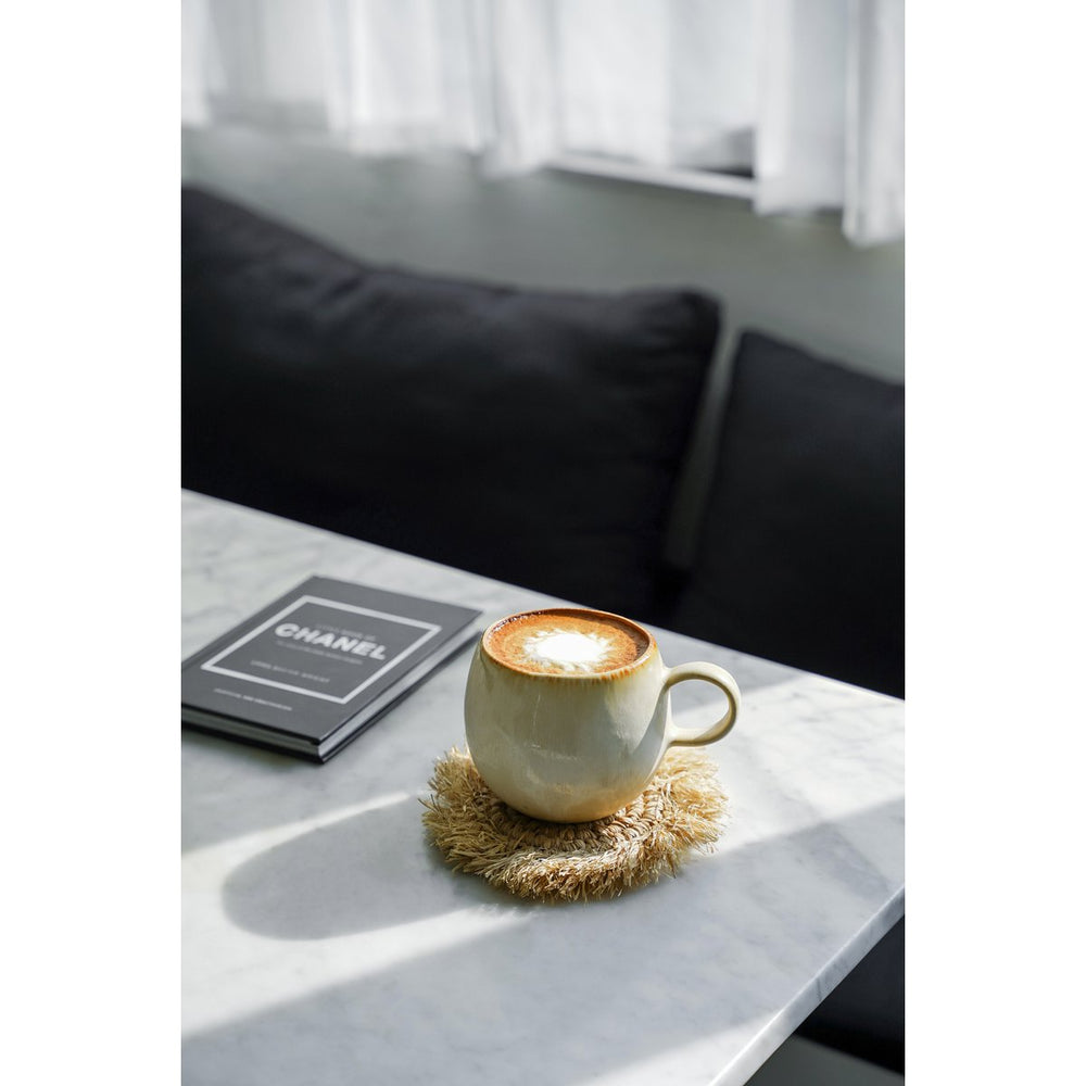 Cup of coffee on a marble surface with a blurred background