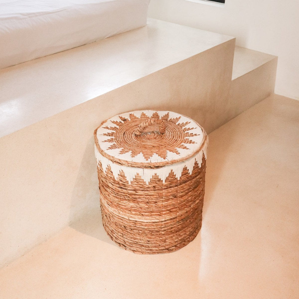Brown woven banana fibre laundry basket with lid and white cotton macrame pattern