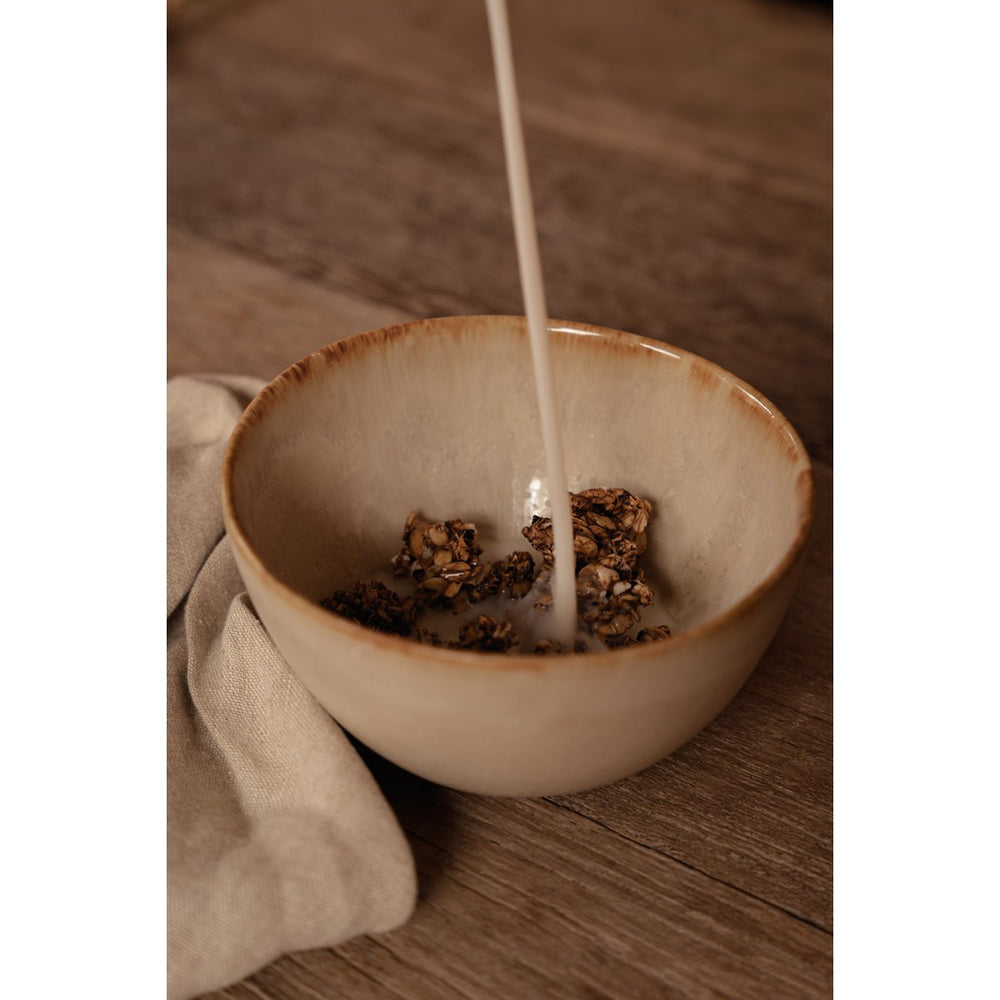 White stoneware cereal bowl with cinnamon-toned drip glaze