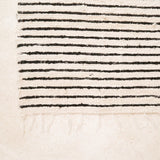 Textured fabric with black and white stripes on a beige background