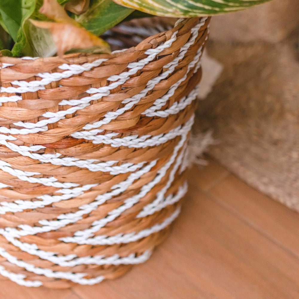 White and beige woven water hyacinth basket with striped pattern