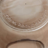 Close-up of a glass container lid with '100% Recycled Glass' text.